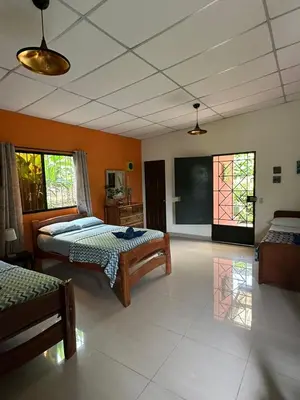 a room with two beds and a chalkboard on the wall at Villa Castillo de Ensueño in Concepción de Ataco