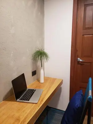 a laptop computer sitting on top of a wooden desk at Hotel Citlalli in San Salvador