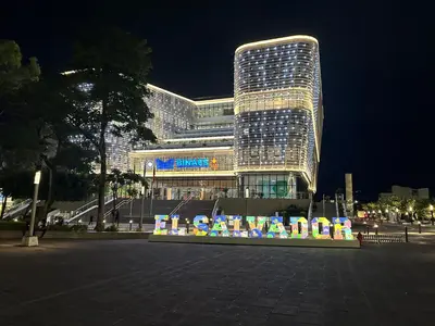 a large building with a sign in front of it at Zona Rosa San Benito 1 cuartito in San Salvador