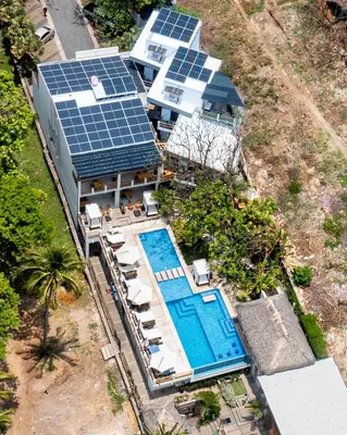 an aerial view of a house with solar panels on it at Palo Verde Sustainable Hotel in El Zonte