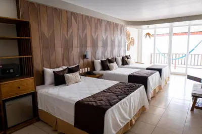 a hotel room with two beds and a balcony at Mar & Sol, Hotel y resturante in La Unión