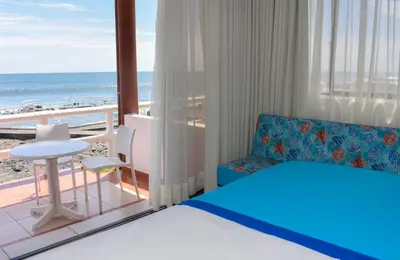 a bedroom with a bed and a view of the beach at Mar & Sol, Hotel y resturante in La Unión