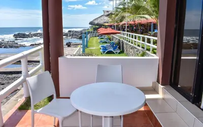a table and chairs on a balcony with a view of the beach at Mar & Sol, Hotel y resturante in La Unión