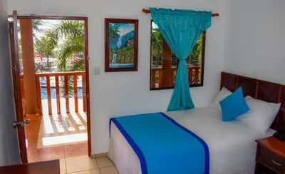 a bedroom with a bed with a window and a balcony at Mar & Sol, Hotel y resturante in La Unión