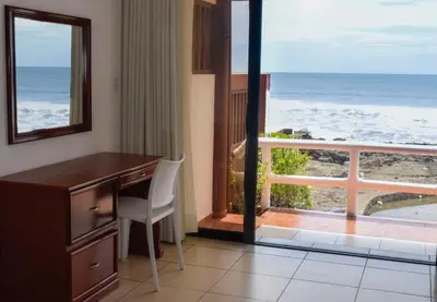 a room with a desk and a view of the ocean at Mar & Sol, Hotel y resturante in La Unión