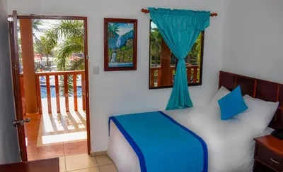 a bedroom with a bed with a window and a balcony at Mar & Sol, Hotel y resturante in La Unión
