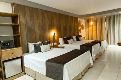 a hotel room with two beds and a television at Mar & Sol, Hotel y resturante in La Unión