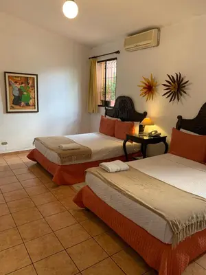 a hotel room with two beds in a room at Hotel La Posada del Angel in San Salvador