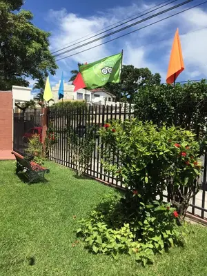 a fence with some plants and a bench in a yard at Hotel La Posada del Angel in San Salvador
