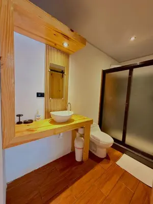 a bathroom with a sink and a toilet at Esencia Nativa in El Zonte
