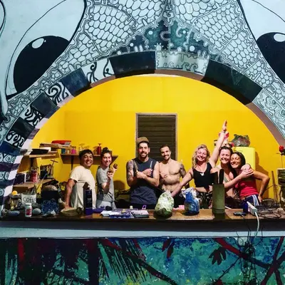 a group of people standing in front of a mirror at Casa de Colores in El Zonte