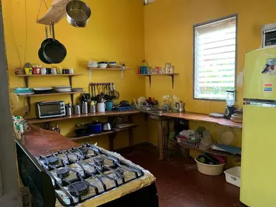a kitchen with a counter and a stove in it at Casa de Colores in El Zonte