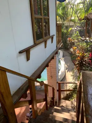 a staircase leading up to a house with a window at Casa de Colores in El Zonte