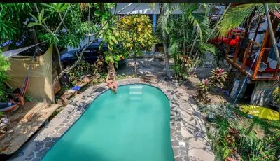 an overhead view of a swimming pool in a garden at Casa de Colores in El Zonte