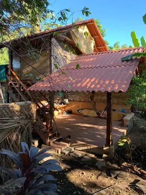 a small house with a red roof and stairs at Casa de Colores in El Zonte