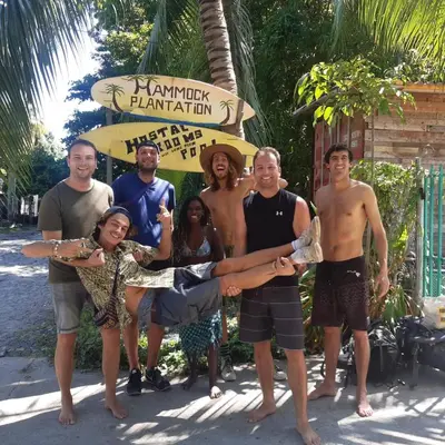a group of people standing in front of a sign at Hammock plantation in El Zonte