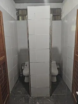 a bathroom with two toilets and two sinks at Hammock plantation in El Zonte