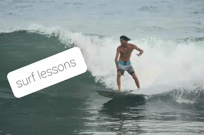 a man riding a wave on a surfboard in the ocean at Hammock plantation in El Zonte