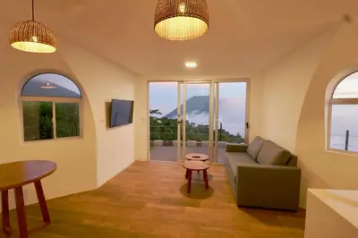 a living room with a couch and a table at Hotel Finca Campo Bello in Cerro Verde