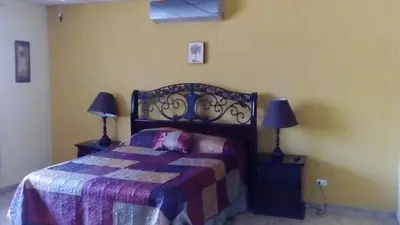 a bedroom with a bed and two lamps in it at Casa San Benito in San Salvador