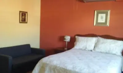 a bedroom with a bed and a chair at Casa San Benito in San Salvador