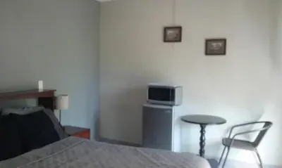 a bedroom with a bed and a table and a tv at Casa San Benito in San Salvador