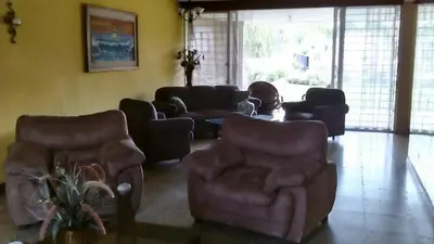 a living room with couches chairs and a table at Casa San Benito in San Salvador