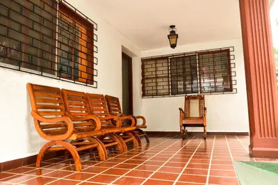 a group of wooden benches sitting in a room at Hotel San José de la Montaña in San Salvador
