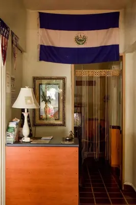 a flag is hanging above a dresser in a room at Hotel San José de la Montaña in San Salvador