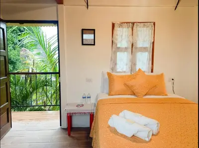 a bedroom with a bed with towels on it at Hostal Koltin Suchitoto in Suchitoto