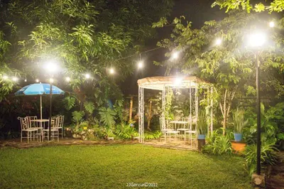 a gazebo in a garden at night with lights at Hostal Koltin Suchitoto in Suchitoto
