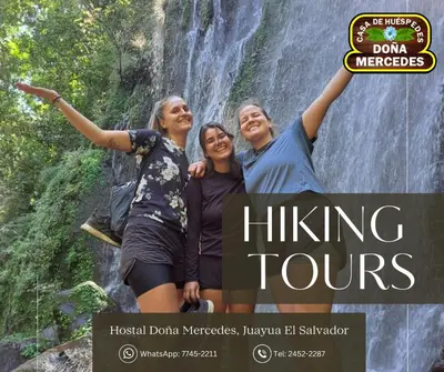 a group of three women standing in front of a waterfall at Hostal Doña Mercedes in Juayúa