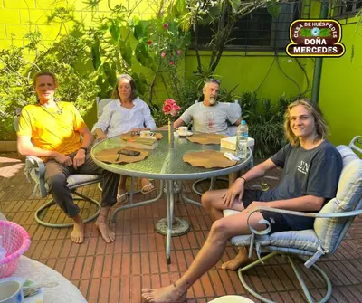a group of people sitting around a table at Hostal Doña Mercedes in Juayúa