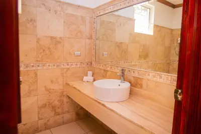 a bathroom with a sink on a wooden counter at Pato Canales Hotel & Resort in San Luis