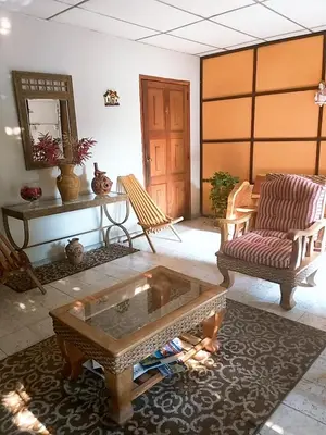 a living room with a coffee table and a couch at Hostal Doña Marta in San Salvador