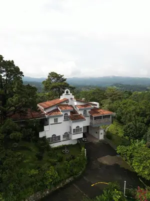 an aerial view of a white house at Las Tilapias Hotel in San Ignacio