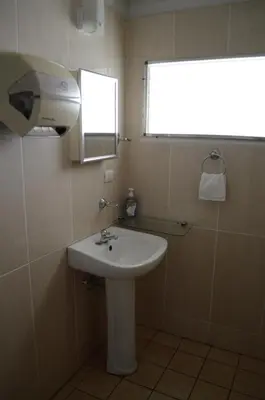 a bathroom with a sink and a mirror and a window at Las Tilapias Hotel in San Ignacio
