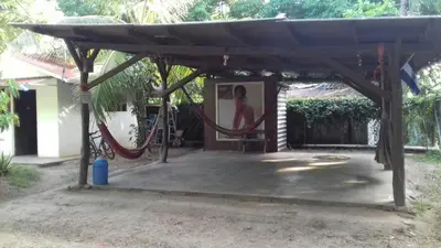 a pergola with a hammock in a yard at Hostal El Balsamo in El Sunzal