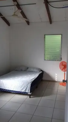 a bedroom with a bed in a room with a window at Hostal El Balsamo in El Sunzal