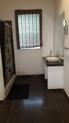 a small kitchen with a sink and a window at Hostal El Balsamo in El Sunzal