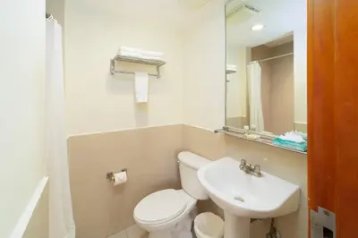 a bathroom with a white toilet and a sink at Comfort Inn Real San Miguel in San Miguel