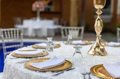a white table with plates and napkins and wine glasses at Comfort Inn Real San Miguel in San Miguel