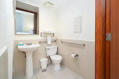 a bathroom with a toilet and a sink at Comfort Inn Real San Miguel in San Miguel