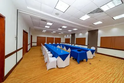a conference room with blue tables and white chairs at Comfort Inn Real La Union in La Unión
