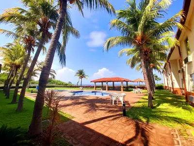 a resort with palm trees and a swimming pool at Comfort Inn Real La Union in La Unión