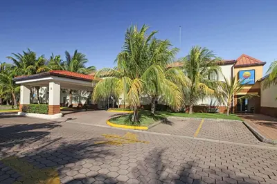 a gas station with palm trees in front of it at Comfort Inn Real La Union in La Unión