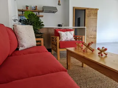 a living room with red couches and a coffee table at Garten Hotel in El Zonte