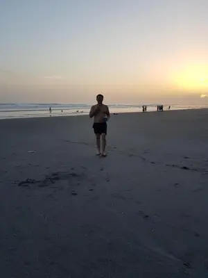 a man walking on the beach at sunset at Rancho villas de alicia in La Paz