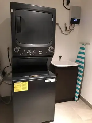 a microwave oven sitting on top of a refrigerator at APARTAMENTO CON LA MEJOR VISTA DE SAN SALVADOR in San Salvador