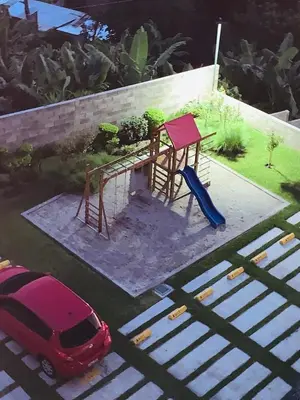 a red car parked in a parking lot with a playground at APARTAMENTO CON LA MEJOR VISTA DE SAN SALVADOR in San Salvador